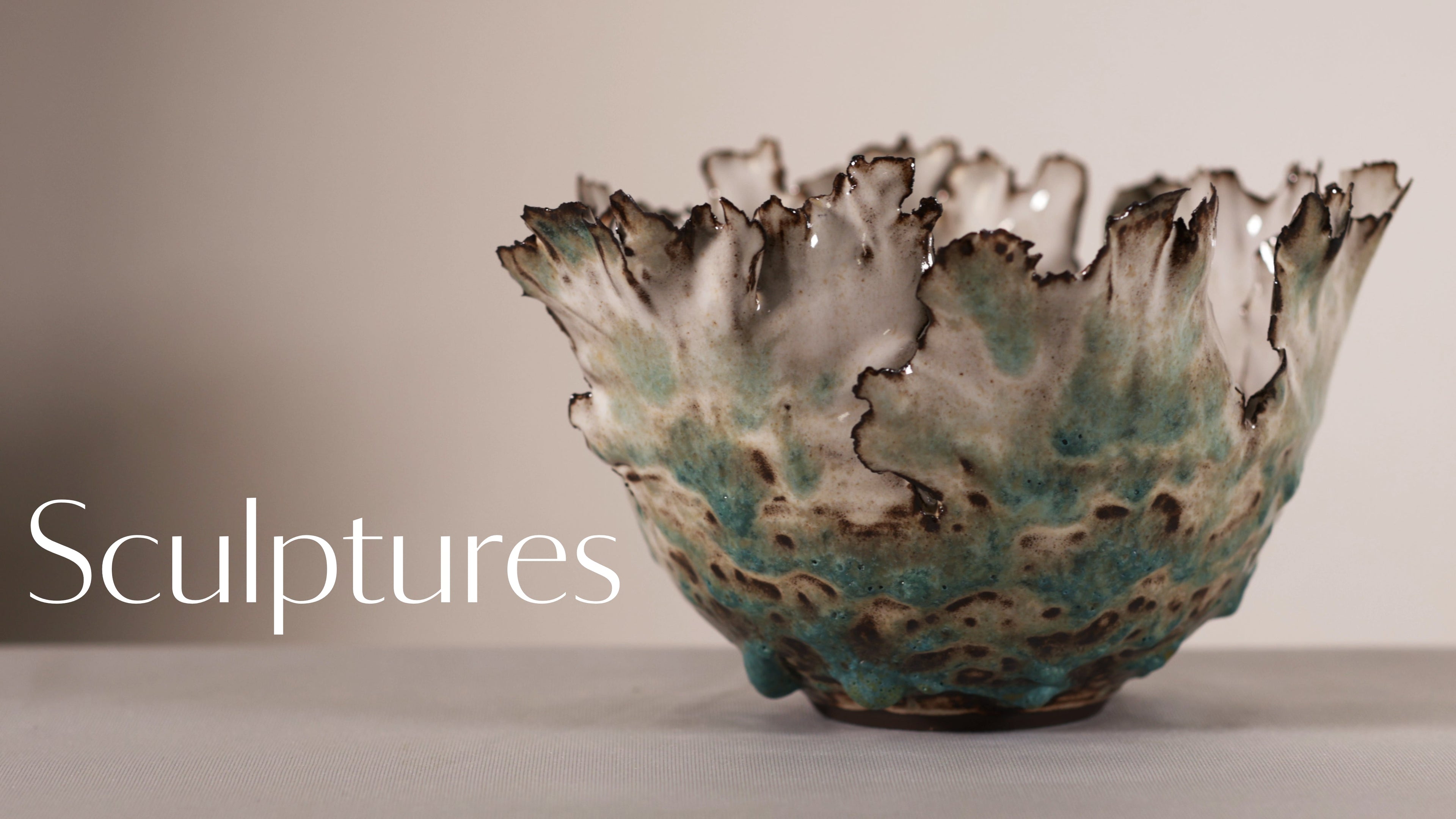 Ceramic bowl with textured surface on a plain background, labeled 'Sculptures'.