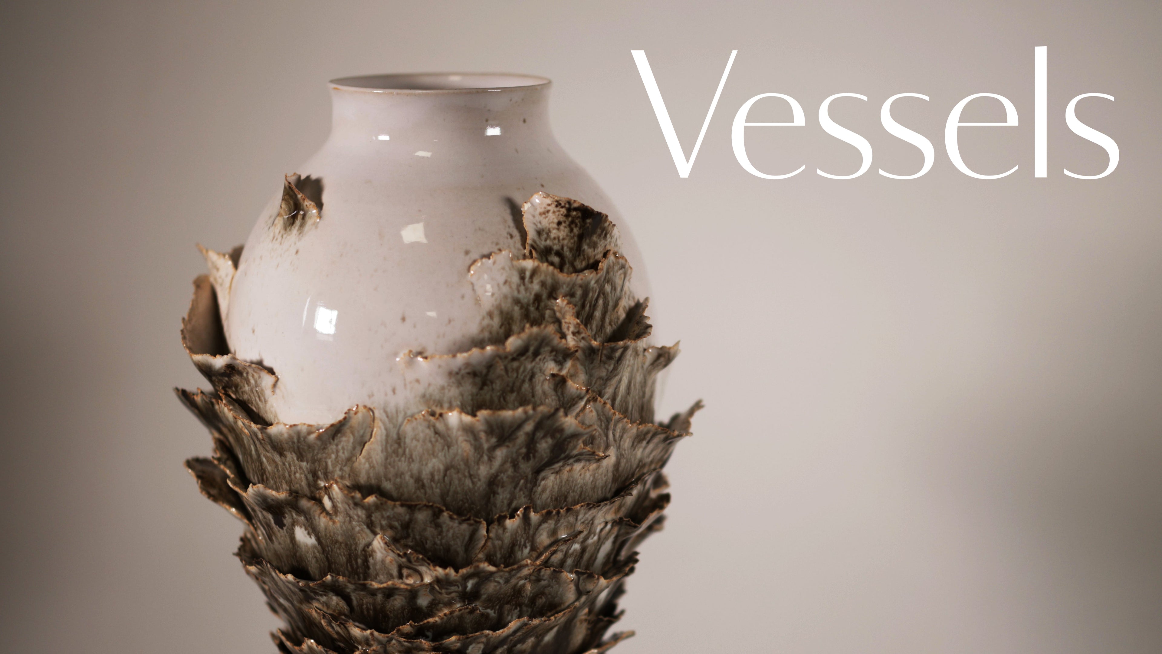 Ceramic vase with textured surface on a plain background, labeled 'Vessels'.