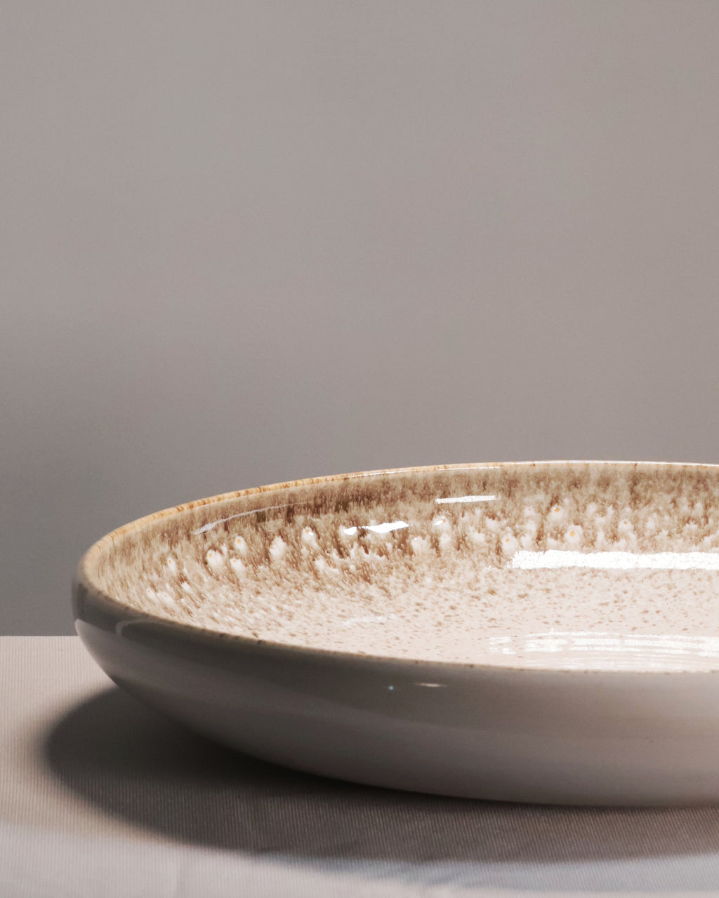 Ceramic bowl with textured surface on a gray background