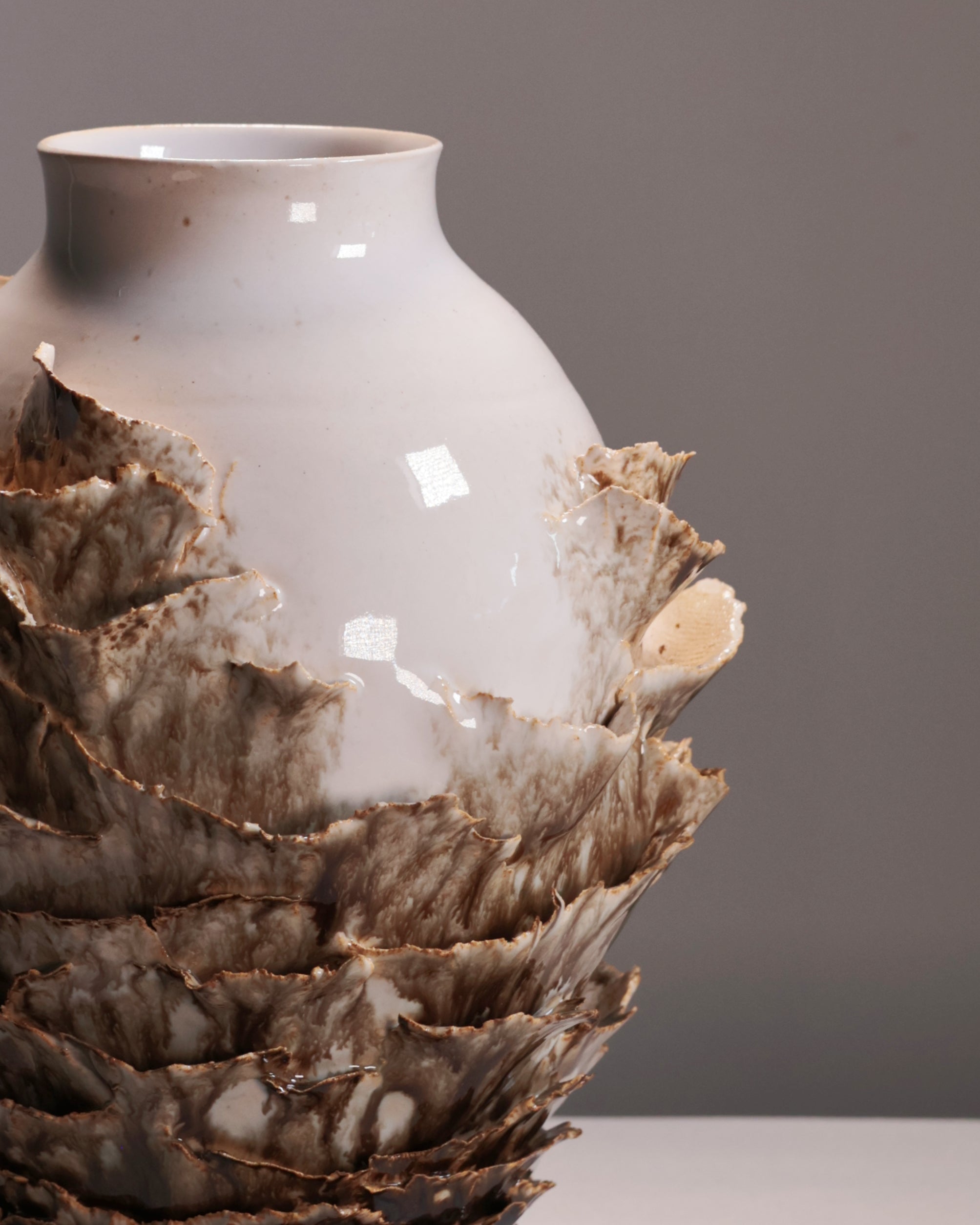 Vase with textured base on a plain background