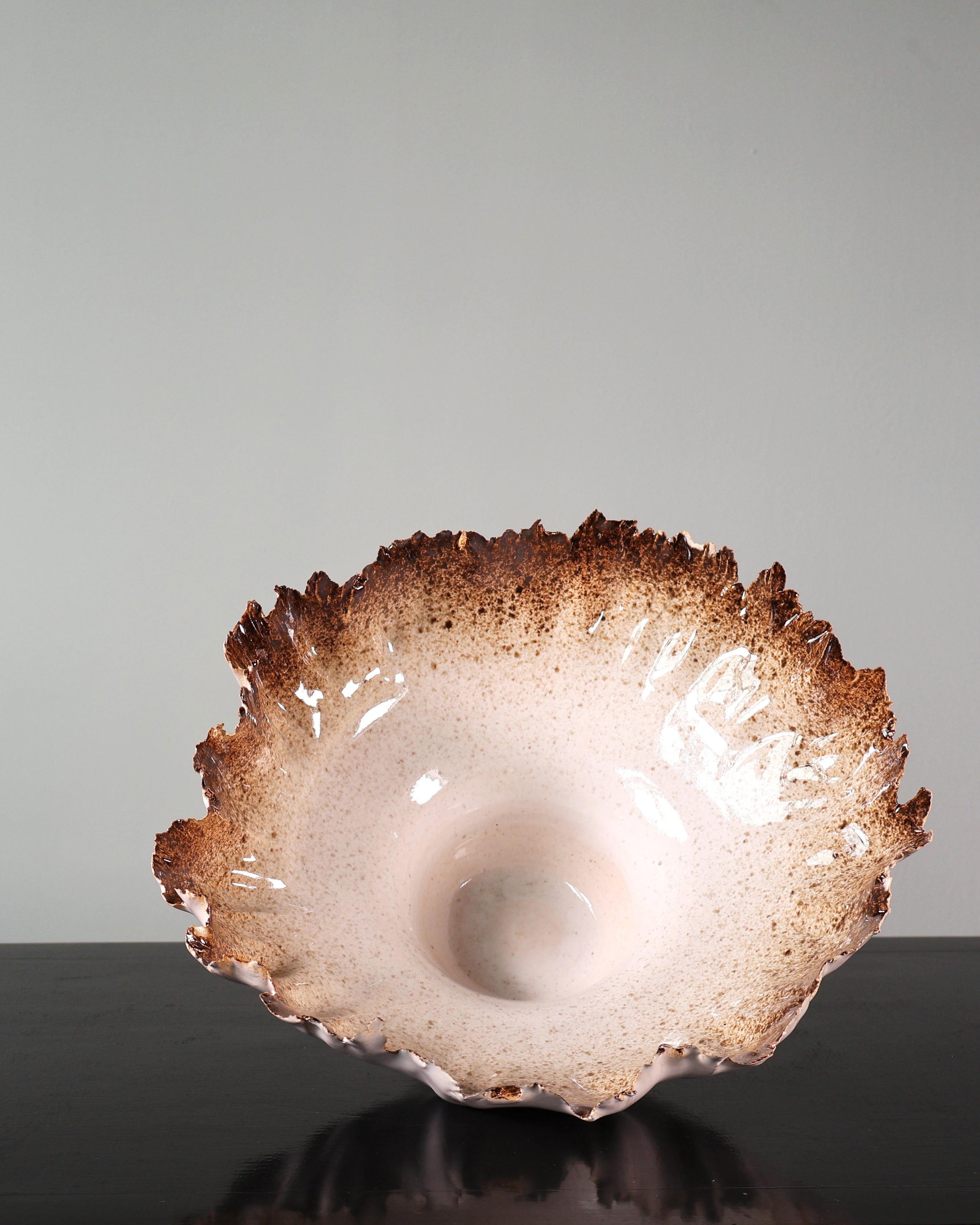 Decorative ceramic bowl with unique texture on a gray background