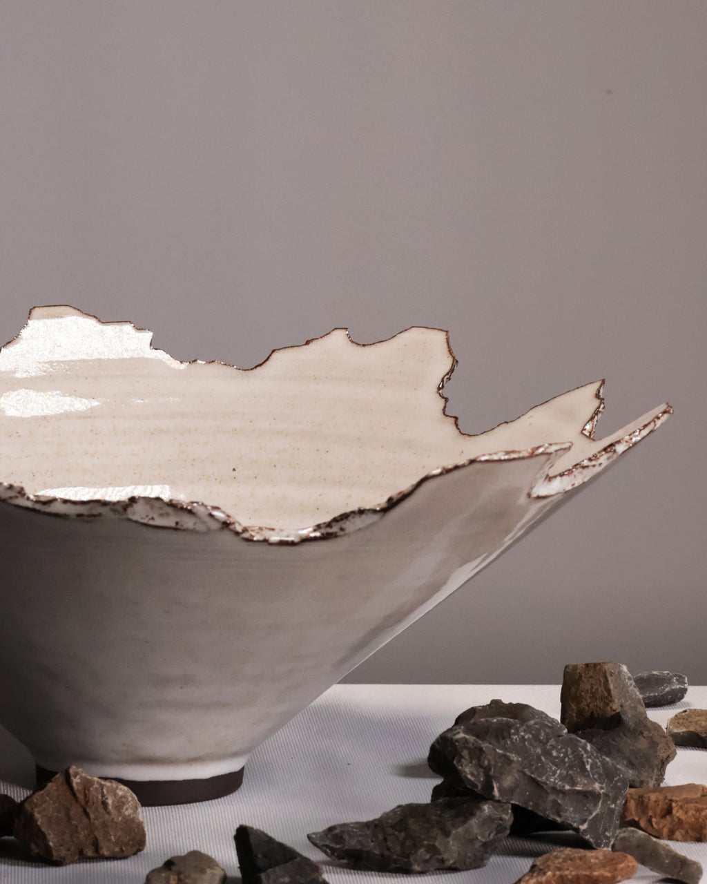 Ceramic bowl with textured edge on a gray background