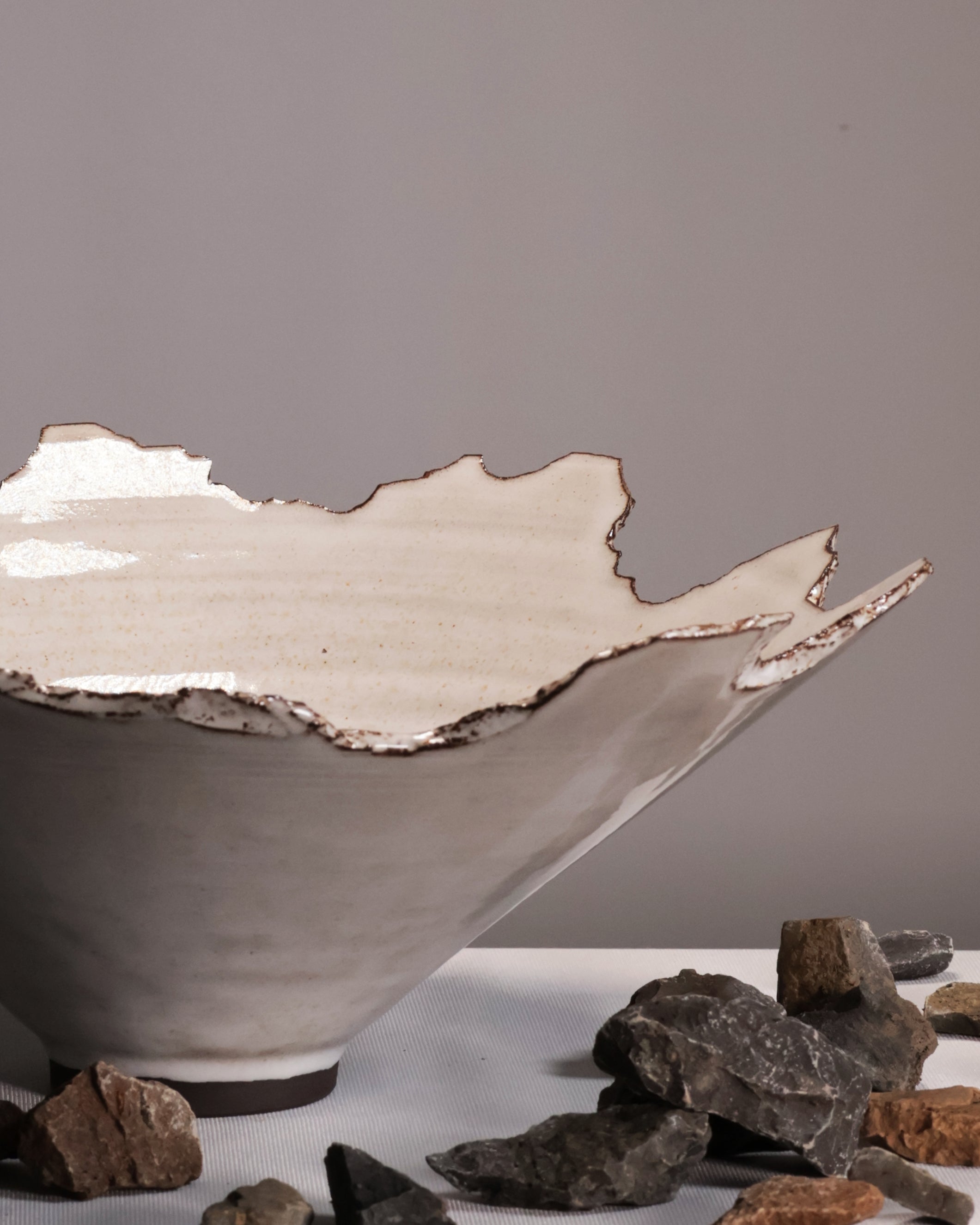 Ceramic bowl with textured edge on a gray background