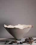 Ceramic bowl with textured surface on a gray background