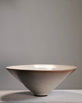 Ceramic bowl with a textured surface on a gray background