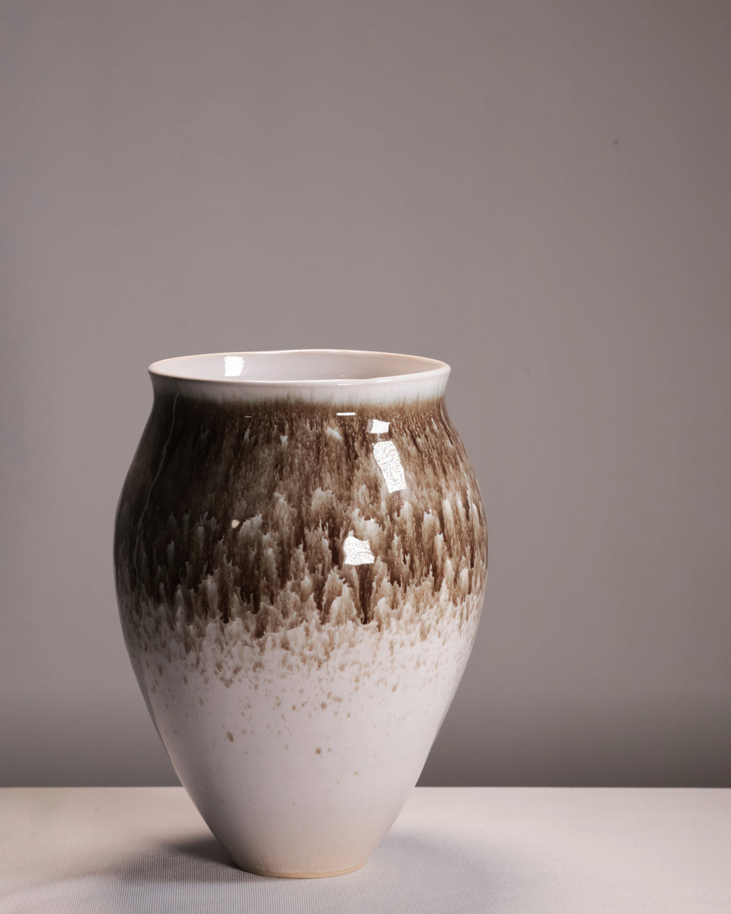 Ceramic vase with gradient finish on a neutral background